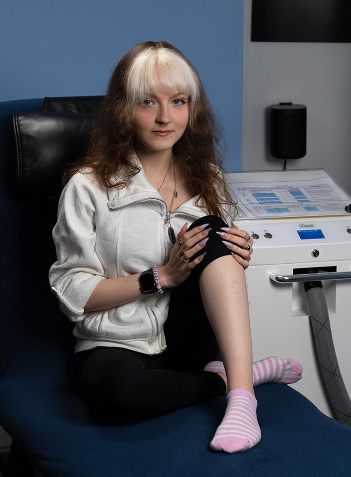 Young alternative woman sitting on treatment chair ready for laser